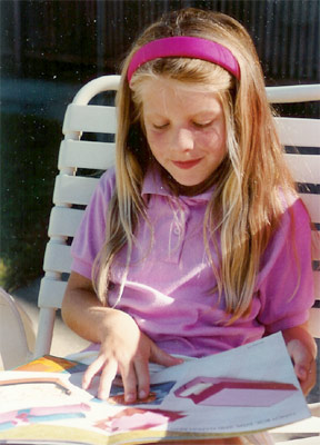 Jessica reading an origami book at the pool circa third grade